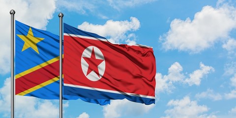 Congo and North Korea flag waving in the wind against white cloudy blue sky together. Diplomacy concept, international relations.
