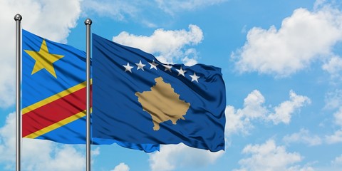 Congo and Kosovo flag waving in the wind against white cloudy blue sky together. Diplomacy concept, international relations.