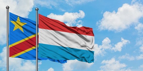 Congo and Luxembourg flag waving in the wind against white cloudy blue sky together. Diplomacy concept, international relations.