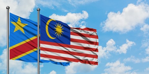 Congo and Malaysia flag waving in the wind against white cloudy blue sky together. Diplomacy concept, international relations.