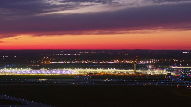 Detroit Michigan Aerial v173 Panning sunset dusk airport cityscape to birdseye looking over field and hangar - October 2017