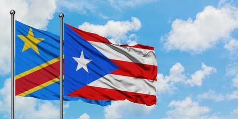 Congo and Puerto Rico flag waving in the wind against white cloudy blue sky together. Diplomacy concept, international relations.