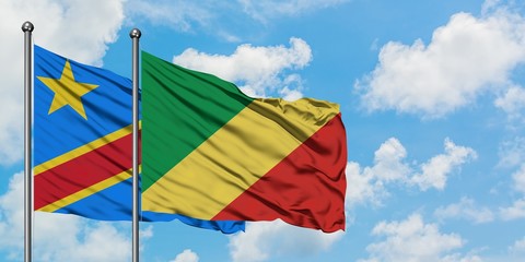 Congo and Republic Of The Congo flag waving in the wind against white cloudy blue sky together. Diplomacy concept, international relations.