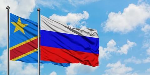 Congo and Russia flag waving in the wind against white cloudy blue sky together. Diplomacy concept, international relations.