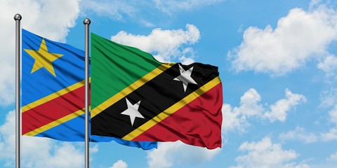 Congo and Saint Kitts And Nevis flag waving in the wind against white cloudy blue sky together. Diplomacy concept, international relations.