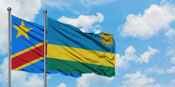 Congo and Rwanda flag waving in the wind against white cloudy blue sky together. Diplomacy concept, international relations.