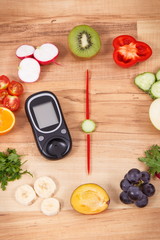 Glucose meter with fruits and vegetables in shape of clock, healthy eating for dinner concept