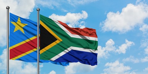 Congo and South Africa flag waving in the wind against white cloudy blue sky together. Diplomacy concept, international relations.