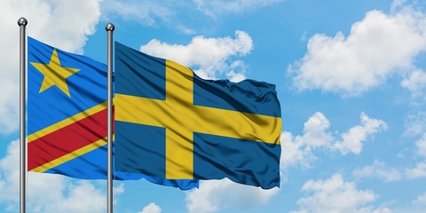 Congo and Sweden flag waving in the wind against white cloudy blue sky together. Diplomacy concept, international relations.