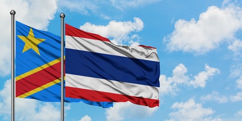 Congo and Thailand flag waving in the wind against white cloudy blue sky together. Diplomacy concept, international relations.