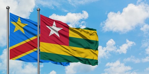 Congo and Togo flag waving in the wind against white cloudy blue sky together. Diplomacy concept, international relations.
