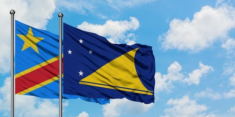 Congo and Tokelau flag waving in the wind against white cloudy blue sky together. Diplomacy concept, international relations.