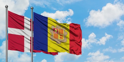 Denmark and Andorra flag waving in the wind against white cloudy blue sky together. Diplomacy concept, international relations.