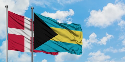 Denmark and Bahamas flag waving in the wind against white cloudy blue sky together. Diplomacy concept, international relations.