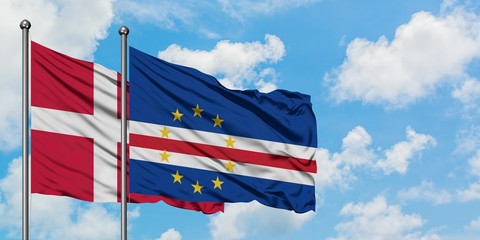 Denmark and Cape Verde flag waving in the wind against white cloudy blue sky together. Diplomacy concept, international relations.