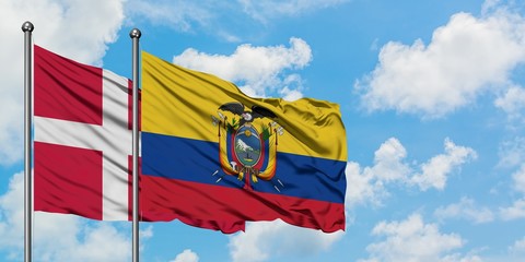 Denmark and Ecuador flag waving in the wind against white cloudy blue sky together. Diplomacy concept, international relations.
