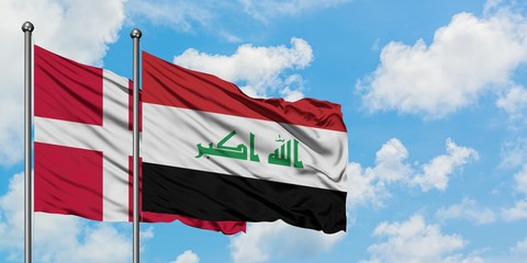 Denmark and Iraq flag waving in the wind against white cloudy blue sky together. Diplomacy concept, international relations.