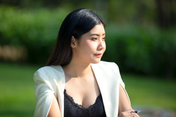 business women white suit standing in park