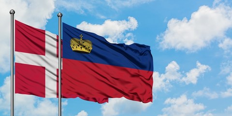 Denmark and Liechtenstein flag waving in the wind against white cloudy blue sky together. Diplomacy concept, international relations.