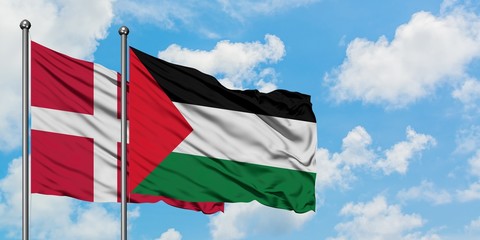 Denmark and Palestine flag waving in the wind against white cloudy blue sky together. Diplomacy concept, international relations.