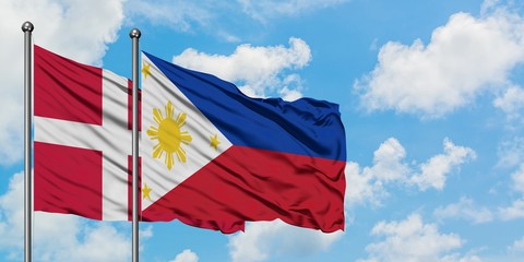 Denmark and Philippines flag waving in the wind against white cloudy blue sky together. Diplomacy concept, international relations.