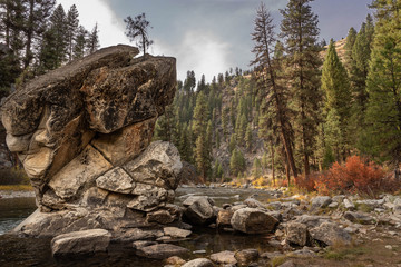 Landscape image of a mountain stream with large rock formation in the foreground. - Powered by Adobe