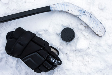 hockey player lying on the snow at the stadium