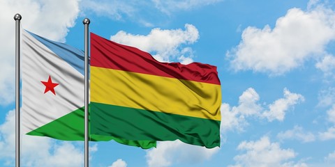Djibouti and Bolivia flag waving in the wind against white cloudy blue sky together. Diplomacy concept, international relations.