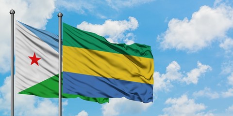 Djibouti and Gabon flag waving in the wind against white cloudy blue sky together. Diplomacy concept, international relations.