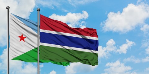 Djibouti and Gambia flag waving in the wind against white cloudy blue sky together. Diplomacy concept, international relations.