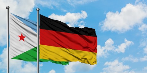 Djibouti and Germany flag waving in the wind against white cloudy blue sky together. Diplomacy concept, international relations.