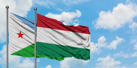 Djibouti and Hungary flag waving in the wind against white cloudy blue sky together. Diplomacy concept, international relations.