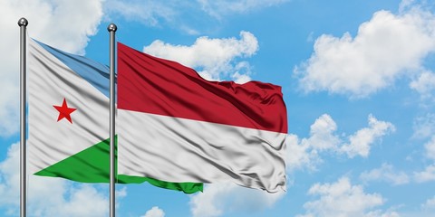 Djibouti and Indonesia flag waving in the wind against white cloudy blue sky together. Diplomacy concept, international relations.