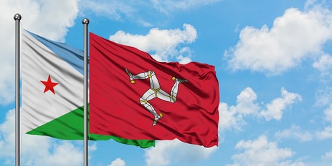 Djibouti and Isle Of Man flag waving in the wind against white cloudy blue sky together. Diplomacy concept, international relations.