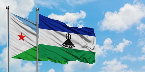 Djibouti and Lesotho flag waving in the wind against white cloudy blue sky together. Diplomacy concept, international relations.