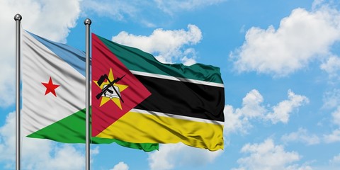 Djibouti and Mozambique flag waving in the wind against white cloudy blue sky together. Diplomacy concept, international relations.