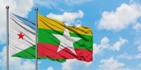 Djibouti and Myanmar flag waving in the wind against white cloudy blue sky together. Diplomacy concept, international relations.