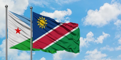 Djibouti and Namibia flag waving in the wind against white cloudy blue sky together. Diplomacy concept, international relations.