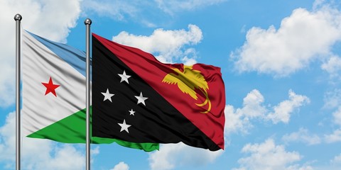 Djibouti and Papua New Guinea flag waving in the wind against white cloudy blue sky together. Diplomacy concept, international relations.