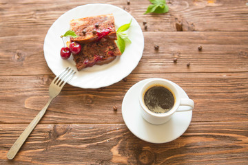 Slice of delicious homemade pie and cup of coffee on table