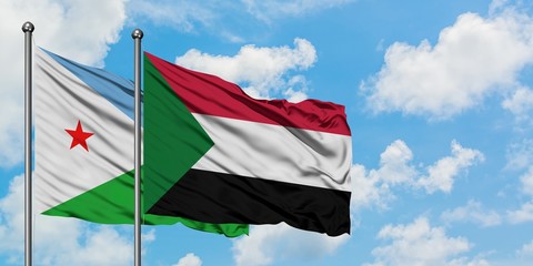 Djibouti and Sudan flag waving in the wind against white cloudy blue sky together. Diplomacy concept, international relations.