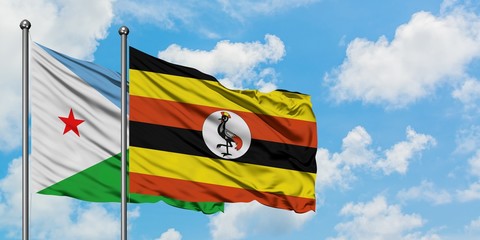 Djibouti and Uganda flag waving in the wind against white cloudy blue sky together. Diplomacy concept, international relations.
