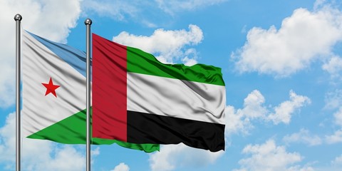 Djibouti and United Arab Emirates flag waving in the wind against white cloudy blue sky together. Diplomacy concept, international relations.