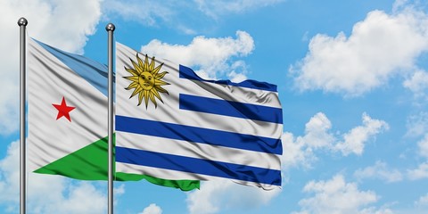 Djibouti and Uruguay flag waving in the wind against white cloudy blue sky together. Diplomacy concept, international relations.