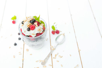 Dessert layered pudding with raspberry and black currant in glass