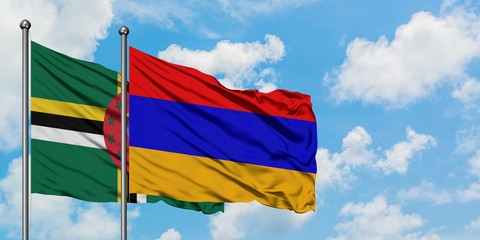 Dominica and Armenia flag waving in the wind against white cloudy blue sky together. Diplomacy concept, international relations.