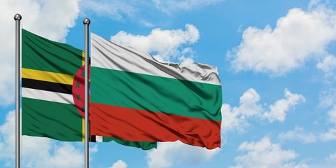 Dominica and Bulgaria flag waving in the wind against white cloudy blue sky together. Diplomacy concept, international relations.