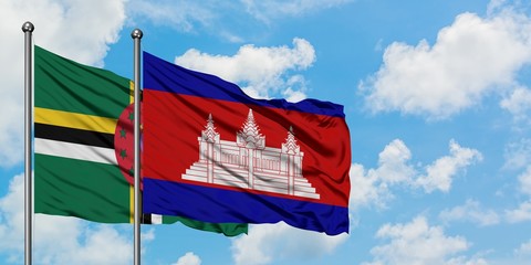 Dominica and Cambodia flag waving in the wind against white cloudy blue sky together. Diplomacy concept, international relations.