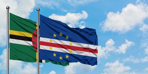 Dominica and Cape Verde flag waving in the wind against white cloudy blue sky together. Diplomacy concept, international relations.