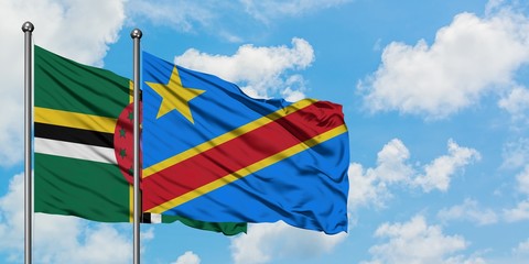 Dominica and Congo flag waving in the wind against white cloudy blue sky together. Diplomacy concept, international relations.